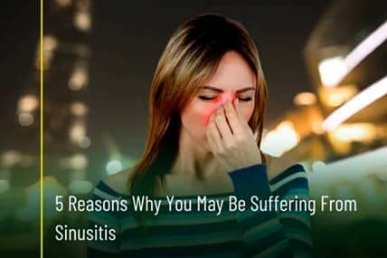 A woman holding her nose as she is suffering from Sinus